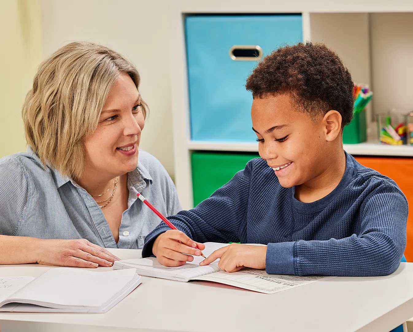Woman teaching child to write
